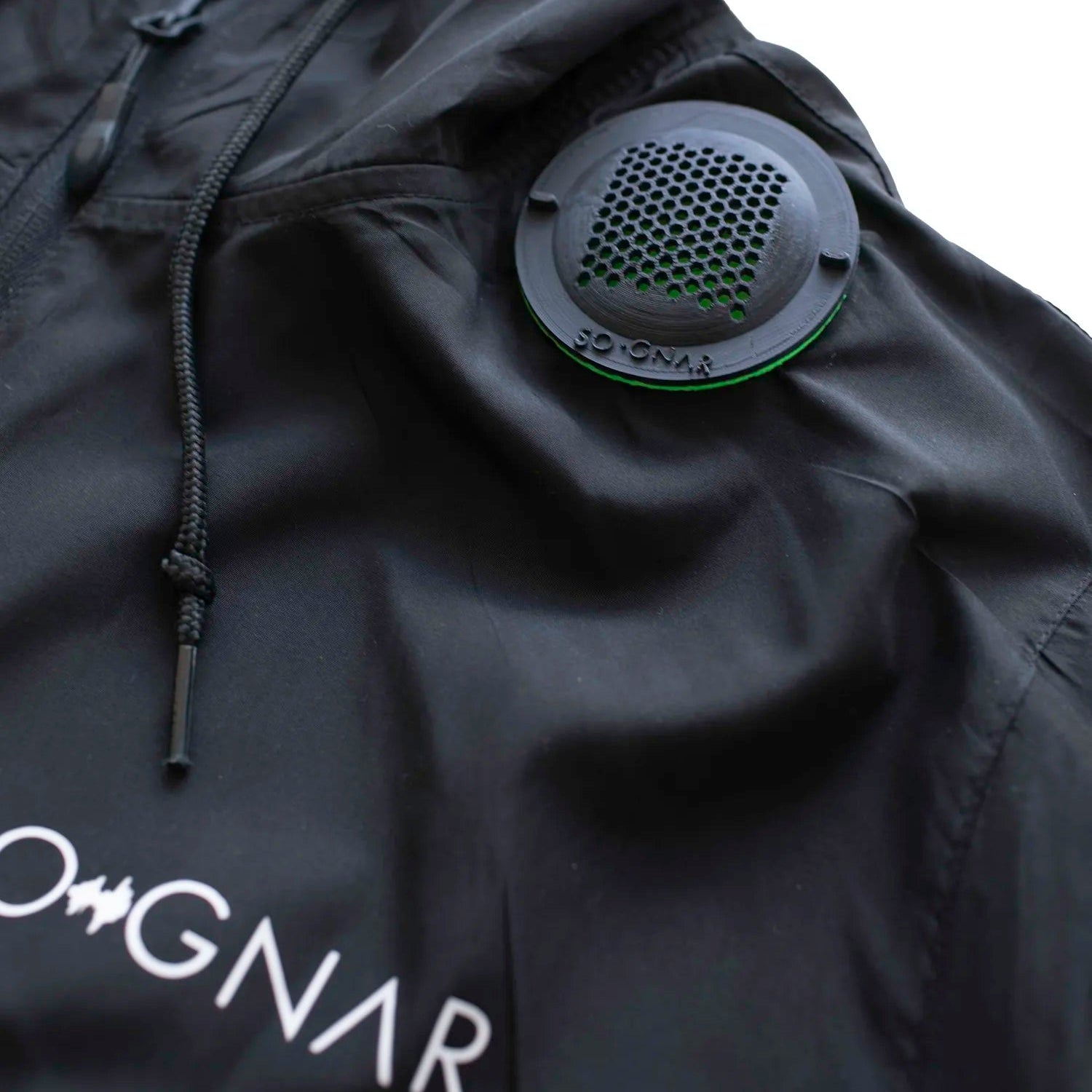 Black jacket with a brand logo and a circular vent on a white background