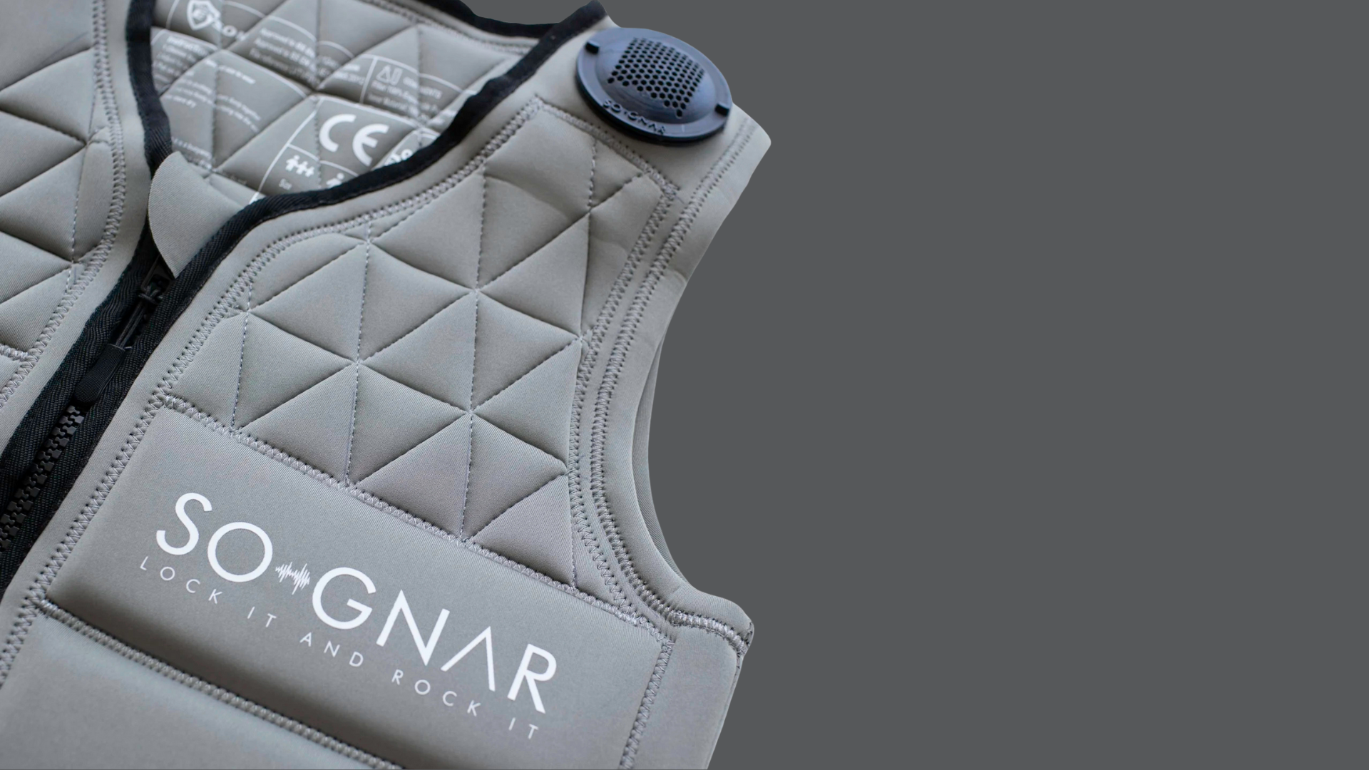 Gray quilted vest with 'SO+GNAR' branding on a gray background
